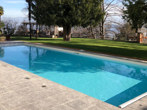 Nature coping stone around a pool with stone paving