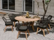 Colosseum round garden table with black Olivia armchairs and a pyramid of lemons