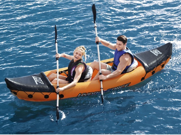 Δύο άτομα κωπηλατούν σε φουσκωτό καγιάκ Lite-Rapid X2 στη θάλασσα