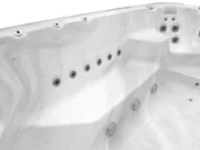 Row of jets along the wall of an Aquas swim spa, white marble