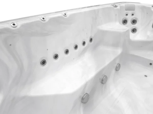 Row of jets along the wall of an Aquas swim spa, white marble