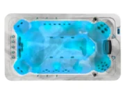 Aquas swim spa, filled with water and lit blue, view from above