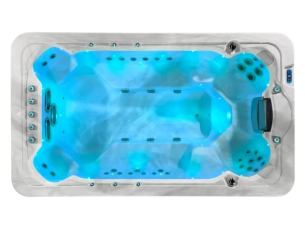Aquas swim spa, filled with water and lit blue, view from above