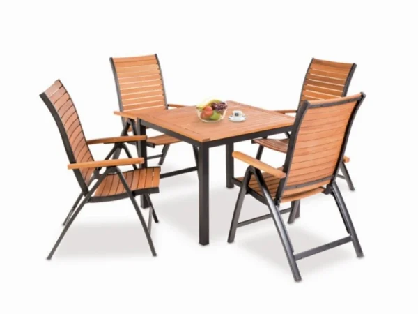 Flamingo garden table with four armchairs from the series and a bowl of fruit