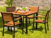 Flamingo garden table on the grass with stackable armchairs and fruit