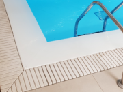 Flexstone stone overflow grate in a pool corner
