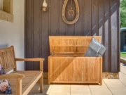 Gentle teak cushion box with cushions inside on a veranda next to a wooden bench