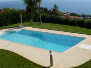 Oasi paving around a pool on a lawn