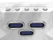 Three oval jets with a chrome frame and a row of jets above them in an Aquas swim spa