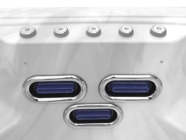 Three oval jets with a chrome frame and a row of jets above them in an Aquas swim spa