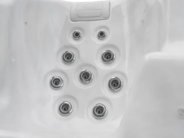 Seat with nine jets and a headrest in an Aquas swim spa, white marble